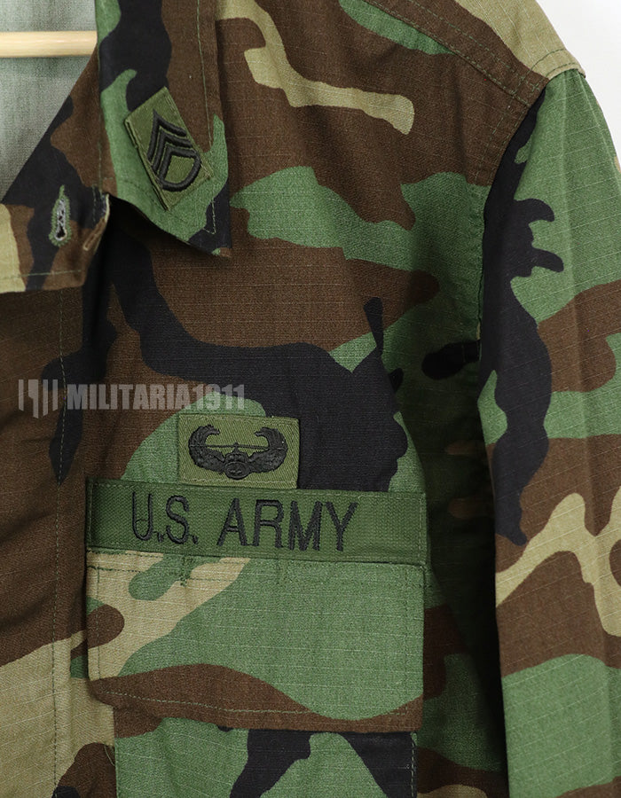 Real U.S. Army Woodland Camouflage Jacket, 2000, with patches.